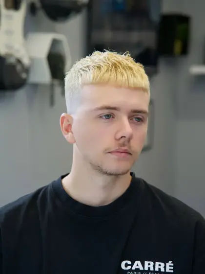 A bleached blond crop with a textured fringe and faded sides, cut by Leandro Herrera