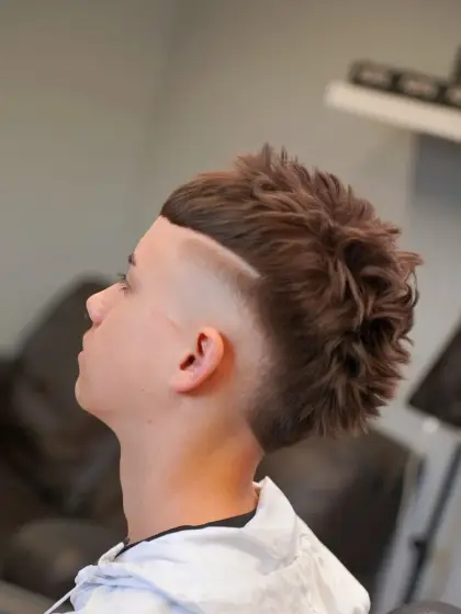 A textured mullet with a line shaved into the side, cut by Leandro Herrera