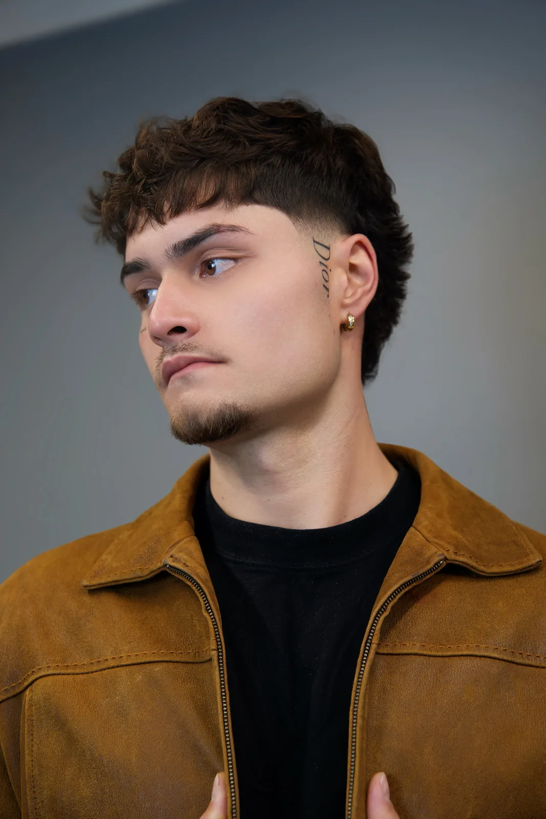 A curly fringe with a fade, cut by Leandro Herrera