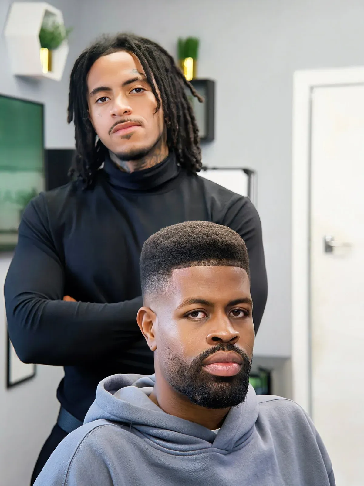 A skin fade with a sharp line-up and a beard, cut by Leandro Herrera
