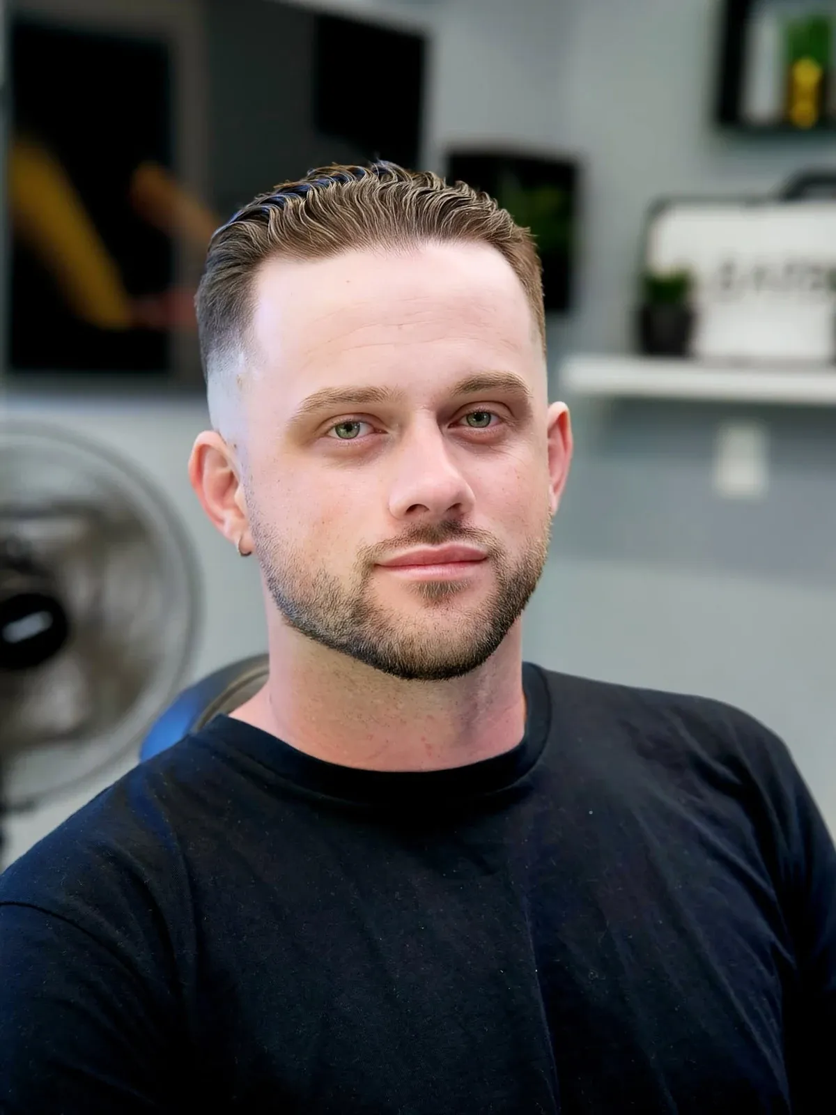 A side part with faded sides and a trimmed beard, cut by Leandro Herrera