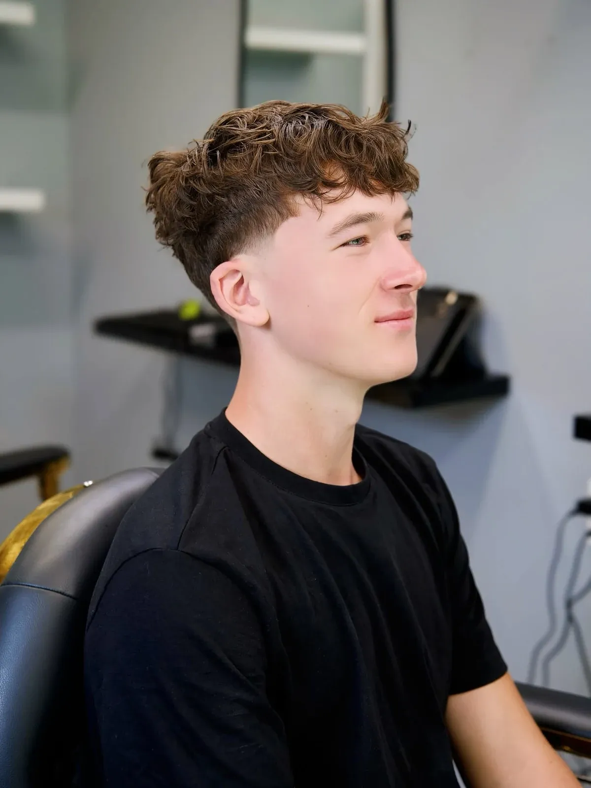 A curly fringe with a tapered side, cut by Leandro Herrera