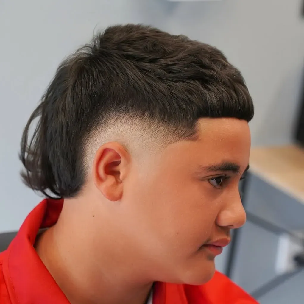A mullet with a skin fade and a hard line, cut by Leandro Herrera