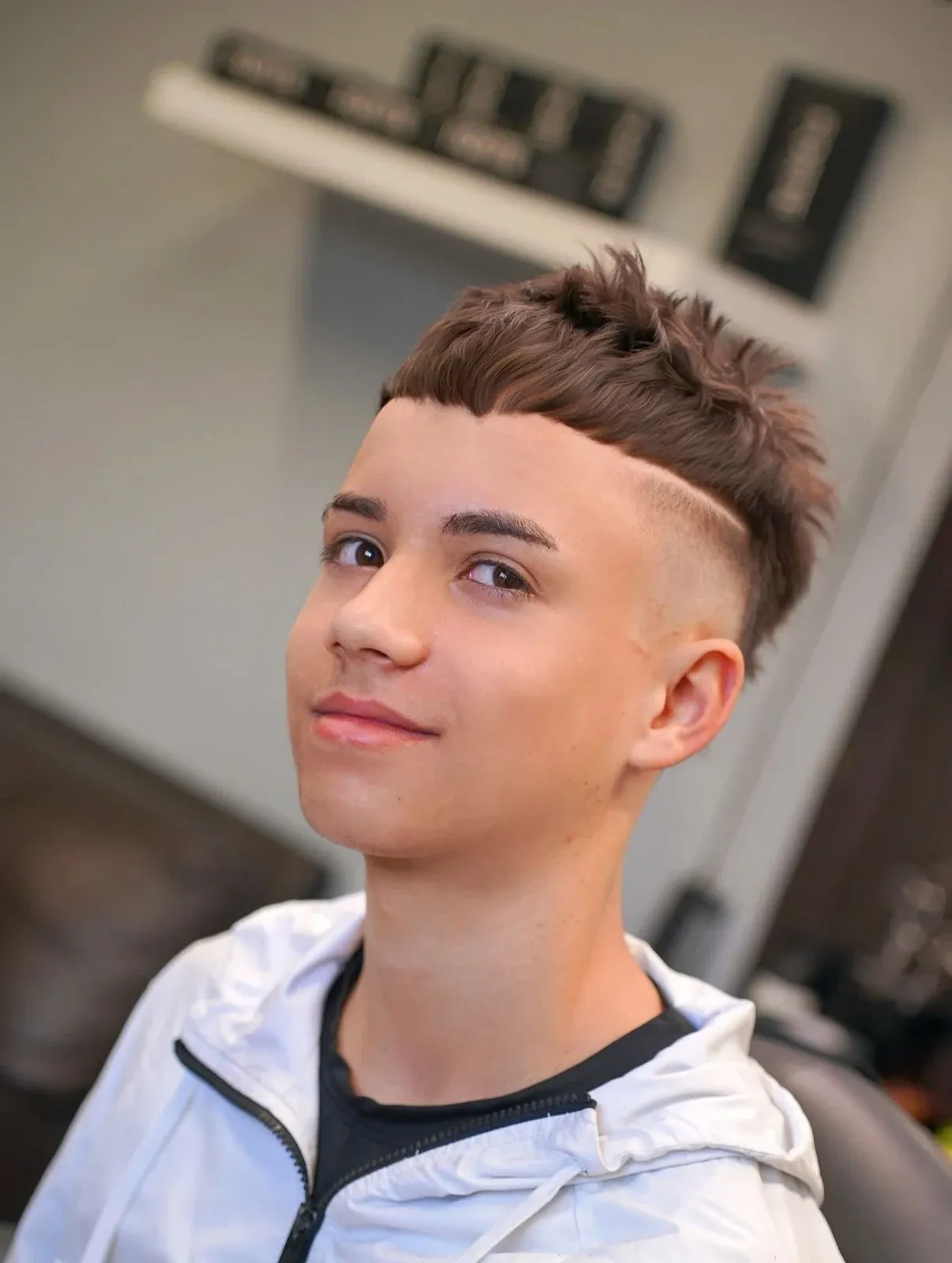 A spiked textured top with a line shaved into the side, cut by Leandro Herrera